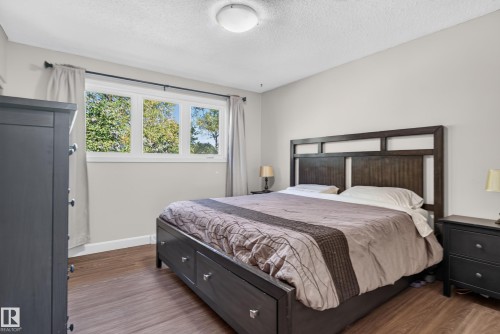 Wood-finish flooring, light gray wall tones, and a multi-pane window - 14611 109 Avenue Nw, Edmonton, AB 