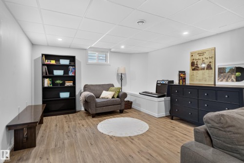Wood-finish flooring, white walls, and a drop ceiling with recessed lighting - 14611 109 Avenue Nw, Edmonton, AB 