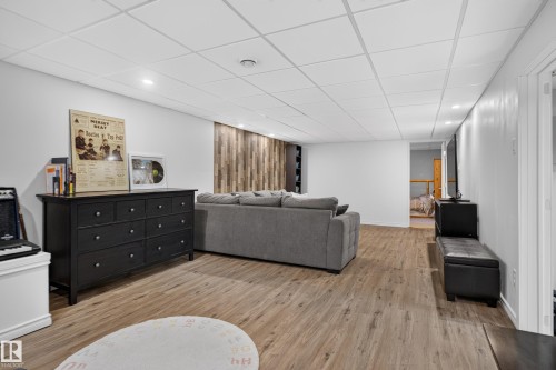 Recessed lighting, wood-finish flooring, white walls, and a wood-panel accent wall - 14611 109 Avenue Nw, Edmonton, AB 
