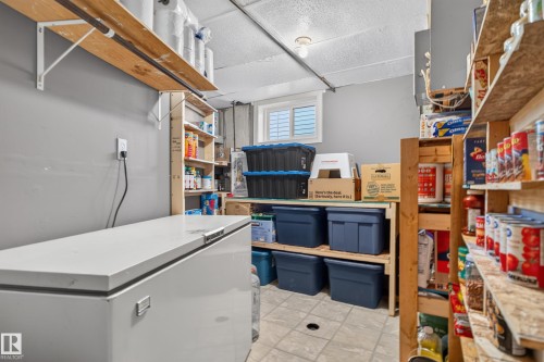 Built-in shelving units, window with blinds, overhead lighting, durable flooring - 14611 109 Avenue Nw, Edmonton, AB 