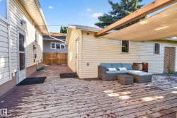 Expansive wood deck with a partial shade covering and privacy fencing - 