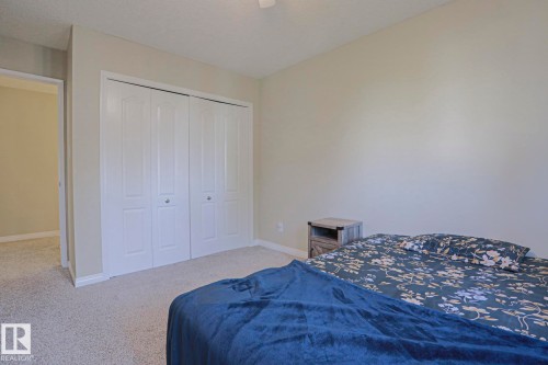 Wall-to-wall carpeting, bi-fold closet doors, and light-toned wall finishes - 319 Telford Court, Leduc, AB 