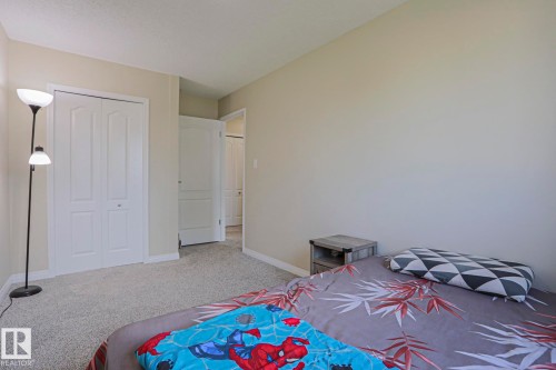 Light-colored wall finishes, light-toned carpeting, and white interior doors - 319 Telford Court, Leduc, AB 