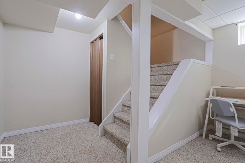 Carpeted flooring, painted walls, and a window - 319 Telford Court, Leduc, AB 