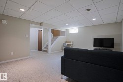 Recessed lighting, drop ceiling, neutral wall tones, light-colored carpeting, and a window - 