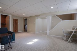 Finished ceiling with recessed lighting, light-toned walls, and carpet flooring - 