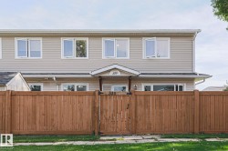 Light-colored siding exterior with white window frames - 