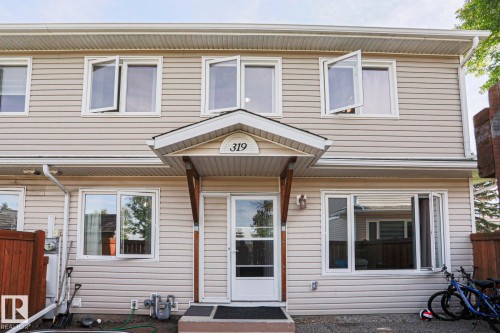 Vinyl siding exterior with white trim - 319 Telford Court, Leduc, AB 