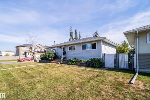 Single-story residence featuring light gray siding and a dark shingle roof - 10245 160 Street Nw, Edmonton, AB 