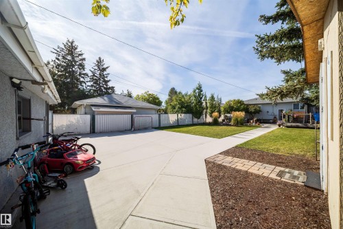 Expansive concrete patio and pathways with a detached garage - 10245 160 Street Nw, Edmonton, AB 