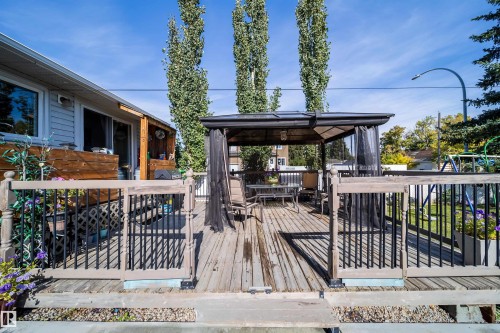 Expansive rear deck featuring wood decking, a built-in privacy screen, and durable railings - 10245 160 Street Nw, Edmonton, AB 