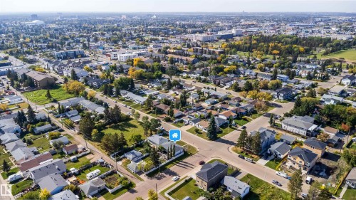 Expansive neighborhood with a mix of residential and commercial properties, featuring mature trees and paved roadways - 10245 160 Street Nw, Edmonton, AB 