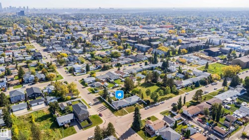 Residential neighborhood with a mix of single-family homes and multi-story buildings, featuring tree-lined streets and varied architectural styles - 10245 160 Street Nw, Edmonton, AB 