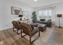 Recessed lighting, wood-finish flooring, and large windows with privacy drapes - 121 Chelles Wynd, St. Albert, AB 