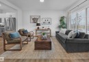 Open-concept living space featuring wood-finish flooring, recessed lighting, and a large sliding glass door - 129 Chelles Wynd, St. Albert, AB 