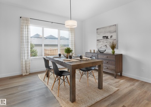 Recessed lighting, wood-finish flooring, large window, and contemporary overhead light fixture - 129 Chelles Wynd, St. Albert, AB 