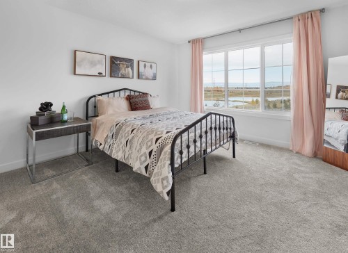 Expansive window with multiple panes, offering ample natural light and distant scenery - 129 Chelles Wynd, St. Albert, AB 