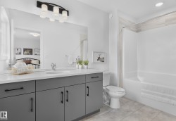 Dual vanity with gray cabinetry, white countertops, and integrated sinks - 