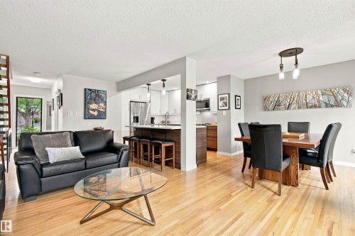 Open-concept living space featuring wood-finish flooring throughout - 141 Hearthstone Nw, Edmonton, AB - Indoor Photo Showing Living Room