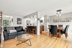 Open-concept living space featuring wood-finish flooring throughout - 