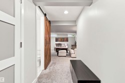 Hallway with light gray walls and a dark wood-finish console table - 