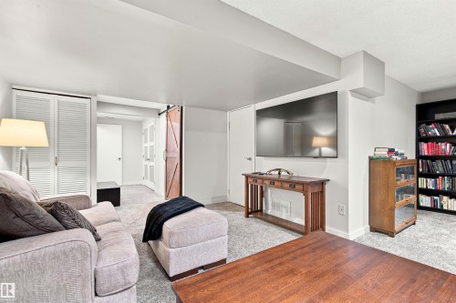 Spacious living area featuring light gray carpeting and white walls - 141 Hearthstone Nw, Edmonton, AB - Indoor