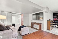 Spacious living area featuring light gray carpeting and white walls - 