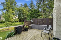 Expansive wooden deck providing an outdoor extension for enjoyment, bordered by a privacy fence - 