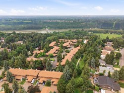 Expansive residential community with numerous brown-roofed townhomes - 