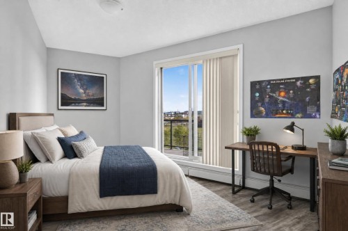 Light grey walls with wood-finish flooring, a full-height window with vertical blinds, and a built-in closet - #411 304 Ambleside Link Li Sw, Edmonton, AB 