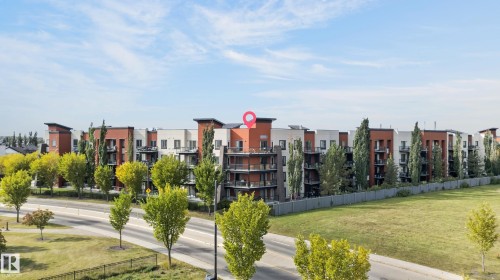 Multi-story building featuring balconies, a neutral color palette, and vertical architectural elements - #411 304 Ambleside Link Li Sw, Edmonton, AB 