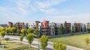 Multi-story building featuring balconies, a neutral color palette, and vertical architectural elements - #411 304 Ambleside Link Li Sw, Edmonton, AB 