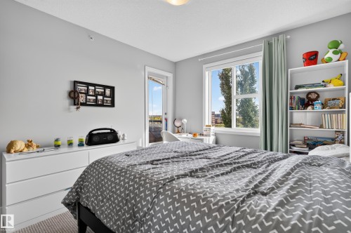 Light gray wall finishes with a window and a door to an outdoor space - #411 304 Ambleside Link Li Sw, Edmonton, AB 