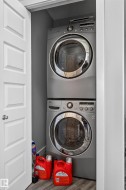 Stackable washer and dryer unit within a dedicated utility closet - 