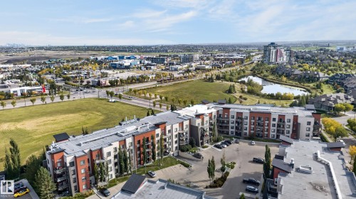 Multi-story residential building with private balconies and surface parking - #411 304 Ambleside Link Li Sw, Edmonton, AB 