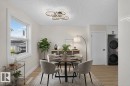 White walls with a textured ceiling, a double-hung window, and wood-finish flooring - 13511 114 Street Nw, Edmonton, AB 