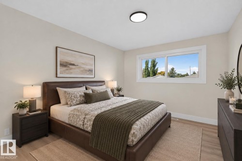 Recessed ceiling light fixture, wood-finish flooring, and a large horizontal window with white trim - 13511 114 Street Nw, Edmonton, AB 