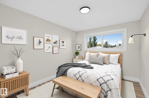 Recessed ceiling light, expansive window, wood-finish flooring, white wall trim, and light gray walls - 13511 114 Street Nw, Edmonton, AB 