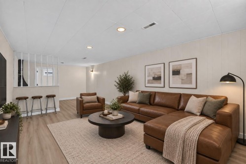 Recessed lighting, wood-finish flooring, white paneled walls, and a half-wall with white vertical slatted accents - 13511 114 Street Nw, Edmonton, AB 