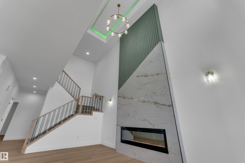 Two-story ceiling with recessed lighting and a decorative chandelier - 4212 63 Street, Beaumont, AB 