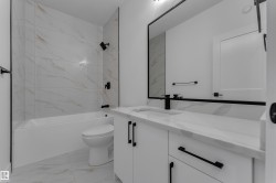 White tiled shower with matte black fixtures - 