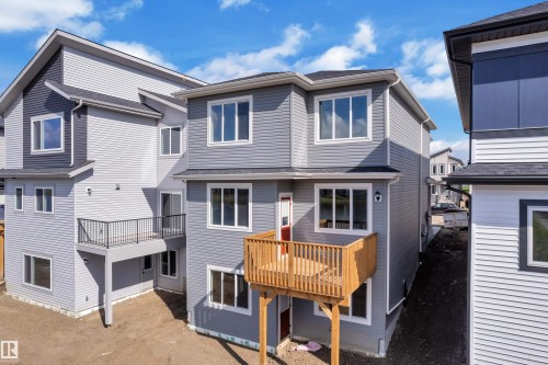 Contemporary multi-level exterior with light gray and dark gray siding - 4212 63 Street, Beaumont, AB 