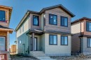 Contemporary exterior featuring multi-toned siding, dark-framed windows, a covered entry, and concrete steps - 9 Tilia Place, Spruce Grove, AB 