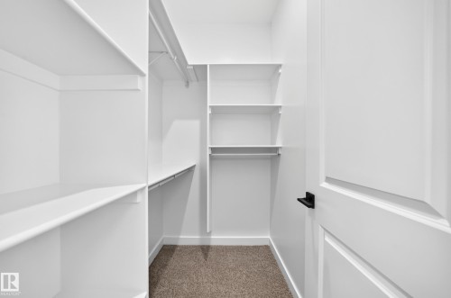 Integrated closet system with multiple shelving units and hanging rods - 9 Tilia Place, Spruce Grove, AB 