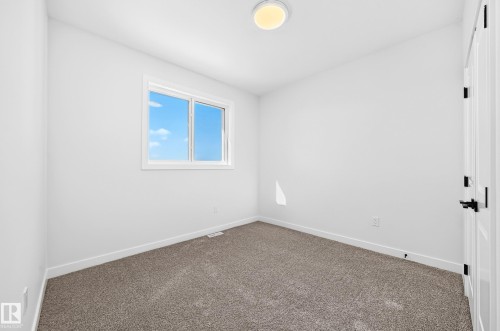 White walls, grey carpeting, and a single window with a white frame - 9 Tilia Place, Spruce Grove, AB 