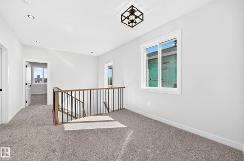 Open landing area featuring gray carpeting, recessed lighting, and a contemporary ceiling fixture - 9 Tilia Place, Spruce Grove, AB 