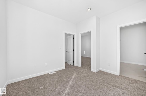 Neutral-toned carpeting, white walls, recessed lighting, and white trim - 9 Tilia Place, Spruce Grove, AB 