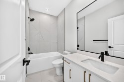 White vanity with a rectangular undermount sink and matte black faucet - 