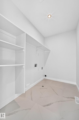 White walls, built-in shelving, white ceiling, recessed lighting, and patterned floor tiling - 9 Tilia Place, Spruce Grove, AB 