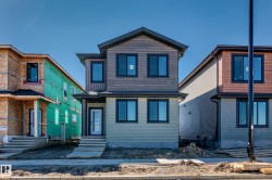 Contemporary exterior with mixed siding, dark-framed windows, a covered entry, and concrete steps - 